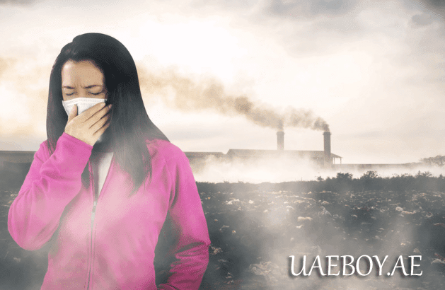 A girl is standing with a mask on her face due to pollution